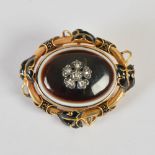 A Victorian yellow metal, enamel, agate and diamond set mourning brooch, the oval agate set with a