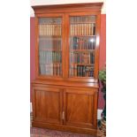 A Victorian mahogany bookcase, the moulded cornice above a pair of glazed cupboard doors opening