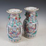 A pair of Chinese porcelain famille rose Canton vases, Qing Dynasty, decorated with panels of