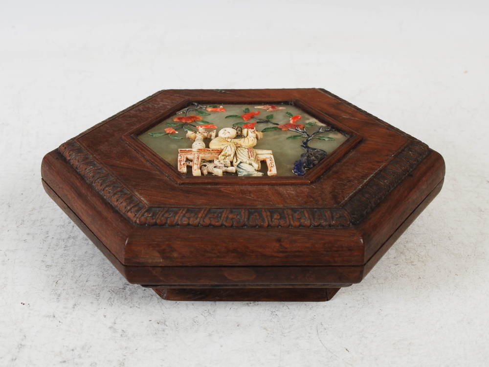 A Chinese dark wood, green stone, coral, ivory and lapis lazuli mounted hexagonal shaped box and