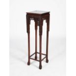 A Chinese tall dark wood jardiniere stand, late 19th/early 20th century, the square top with a