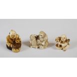 Three Japanese ivory netsuke, Meiji Period, one carved with two monkeys, signed, 3.5cm high x 4cm