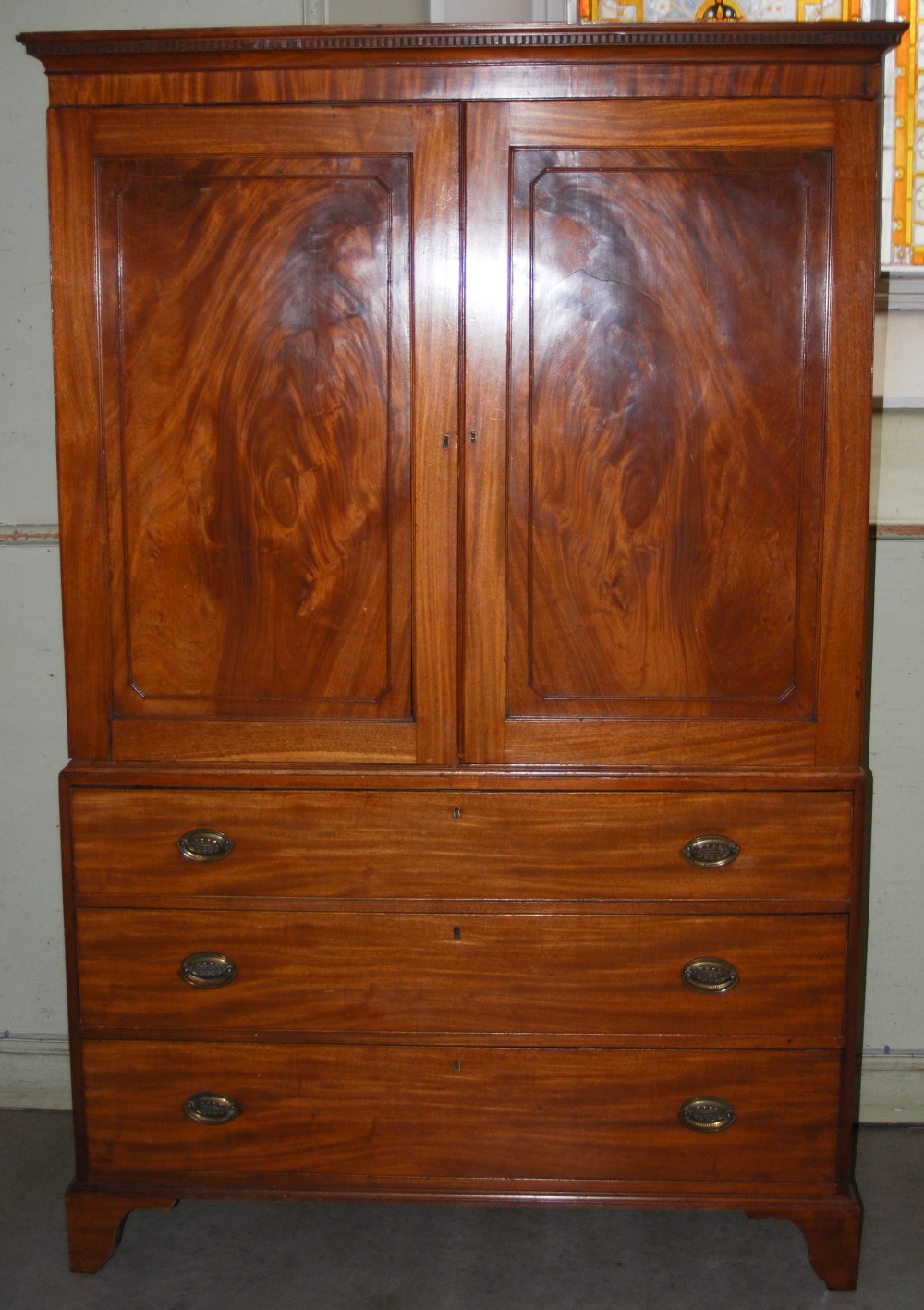 A 19th century mahogany linen press, the moulded cornice and dentil frieze above a pair of - Image 2 of 7