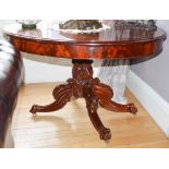 A 19th century mahogany oval centre table, the oval top and plain frieze raised on foliate carved