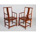 A pair of Chinese dark wood armchairs, the rectangular backs with solid vertical splats carved