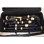 A set of ebony and ivory white metal mounted bagpipes.