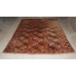 A Turkoman carpet, late 19th/early 20th century, the madder ground centred with three rows of