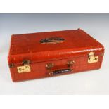 An early 20th century leather covered suitcase, simulating crocodile skin, bearing vintage Cunard