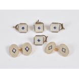 A set of four early 20th century yellow and white metal mother-of-pearl and sapphire set shirt