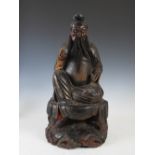 A Chinese carved wood and lacquered figure of a seated Official, probably Ming, 59cm high.