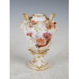 A KPM Berlin porcelain urn, painted with colourful panels of flowers, with applied flowers and
