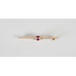 An early 20th century yellow metal ruby and diamond three stone bar brooch, centred with a round