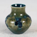 'Leaf and berry' a miniature Moorcroft green ground vase, impressed marks and blue painted mark, 8cm