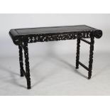 A Chinese dark wood altar table, late 19th/early 20th century, the rectangular panelled top above