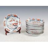 A set of twelve Japanese Imari dishes, Meiji Period, decorated with pavilions in a coastal landscape