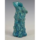 A Japanese turquoise blue glazed Oni vase, decorated in relief with Oni and Mons, 26cm high.