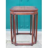 A Chinese dark wood octagonal shaped urn stand, the panelled top raised on eight tall legs united by