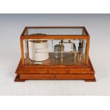 An oak barograph, Short & Mason Ltd, London, with bevelled glass panels and shallow drawer, raised