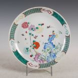 A Chinese porcelain famille rose dish, Qing Dynasty, decorated with rockwork issuing peony within