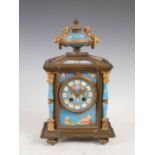 A late 19th century porcelain mounted gilt metal mantel clock, the circular dial with Roman