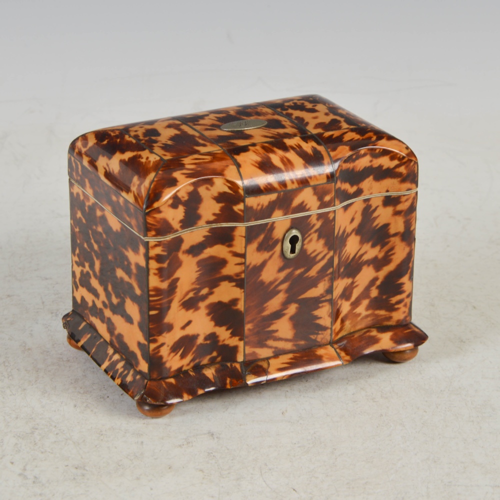 A 19th century tortoiseshell tea caddy, the hinged cover centred with a white metal oval initial