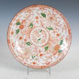 A Chinese porcelain dish, decorated in rouge-de-fer with peony, lotus and chrysanthemum, the details