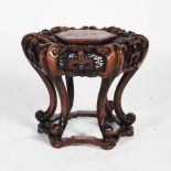 A Chinese hexagonal shaped dark wood jardiniere stand, the top with a hexagonal shaped plinth