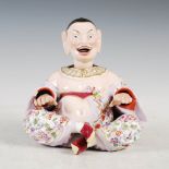 A Meissen porcelain nodding head Pagoda figure, with moving head, tongue and hands, the cross legged