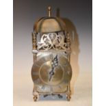 An antique lantern clock, the circular dial with Roman numerals and anchor escapement, 35cm high.