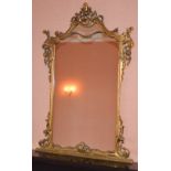 A 19th century gilt wood overmantel mirror, the shaped rectangular mirror plate within a C-scroll