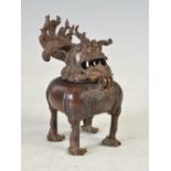 A Chinese bronze shishi form censer, Qing Dynasty, with hinged head, 14cm high x 8cm wide.