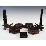 A collection of seven Chinese dark wood stands, late 19th/ early 20th century, comprising; two plate