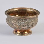 A Chinese silver salt/ small bowl, Qing Dynasty, with embossed and chased decoration of stag, birds,