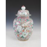 A Chinese famille rose porcelain jar and cover, Qing Dynasty, decorated with four shaped oval panels