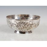 A Chinese silver plated bowl, decorated in relief with chrysanthemum and foliage, raised on short