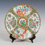 A Chinese porcelain famille rose Canton plate, Qing Dynasty, decorated with panels of figures