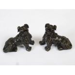 A pair of Chinese bronze shi shi, Qing Dynasty, 6cm high x 7.5cm.