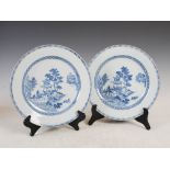 A pair of Chinese blue and white porcelain plates, Qing Dynasty, decorated with pavilions, trees and