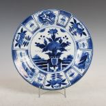 A Japanese blue and white arita charger, Edo Period, decorated with a central circular panel of