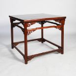 A Chinese dark wood centre table, the square panelled top above an open frieze with scroll carved