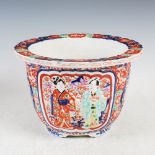 A Japanese Imari jardiniere, late 19th/early 20th century, decorated with two panels enclosing