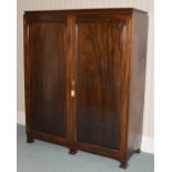 A mahogany wardrobe, attributed to Whytock & Reid, fitted with two panelled cupboard doors opening