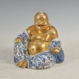 A Chinese porcelain blue and white buddha, late 19th/ early 20th century, modelled in typical seated