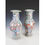 A near pair of Chinese porcelain famille rose Canton vases, Qing Dynasty, decorated with rectangular