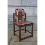 A Chinese dark wood chair, late Qing Dynasty, the rectangular panelled back carved in relief with