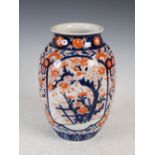 A Japanese Imari porcelain jar, Meiji Period, decorated with panels of trees with flowering branches