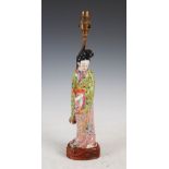 A Chinese porcelain famille rose figure of a lady, 20th century, mounted as a table lamp on fitted