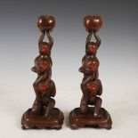 A pair of cold painted bronzed spelter monkey form candlesticks, early 20th century, comprising