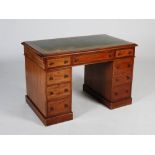 A 19th century mahogany pedestal desk, the rectangular top with green and gilt tooled leather