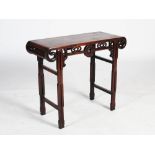 A small Chinese dark wood altar table, the rectangular panelled top above a pierced frieze centred